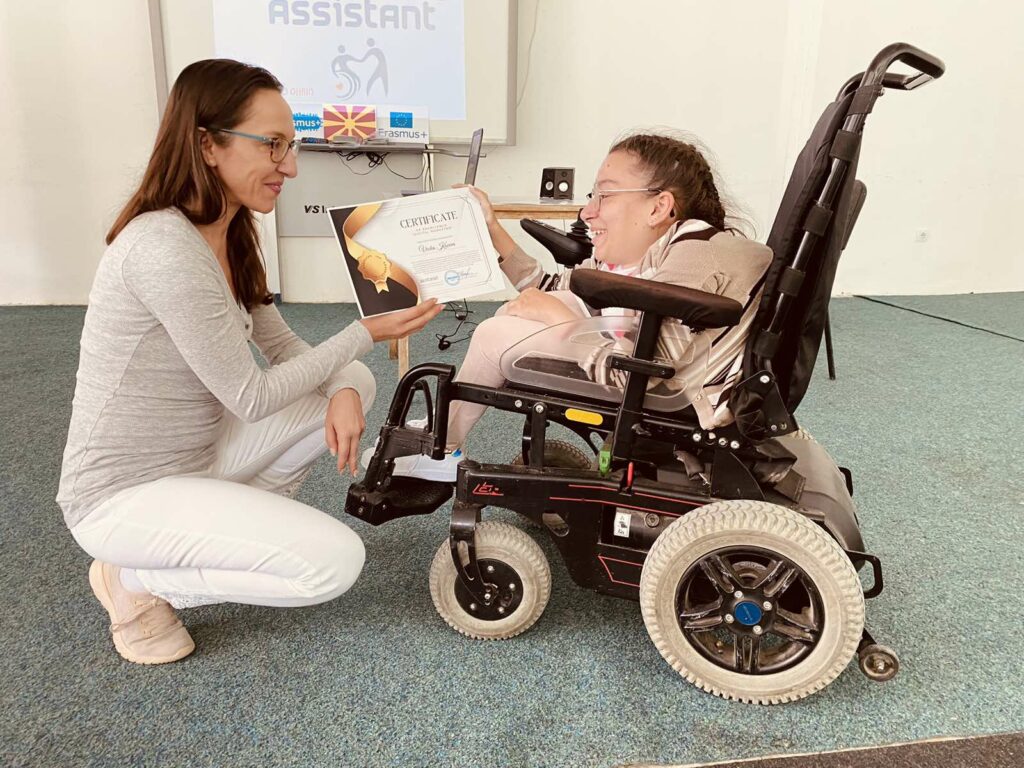 Vecka Koceva, a person with cerebral palsy accepting the diploma.