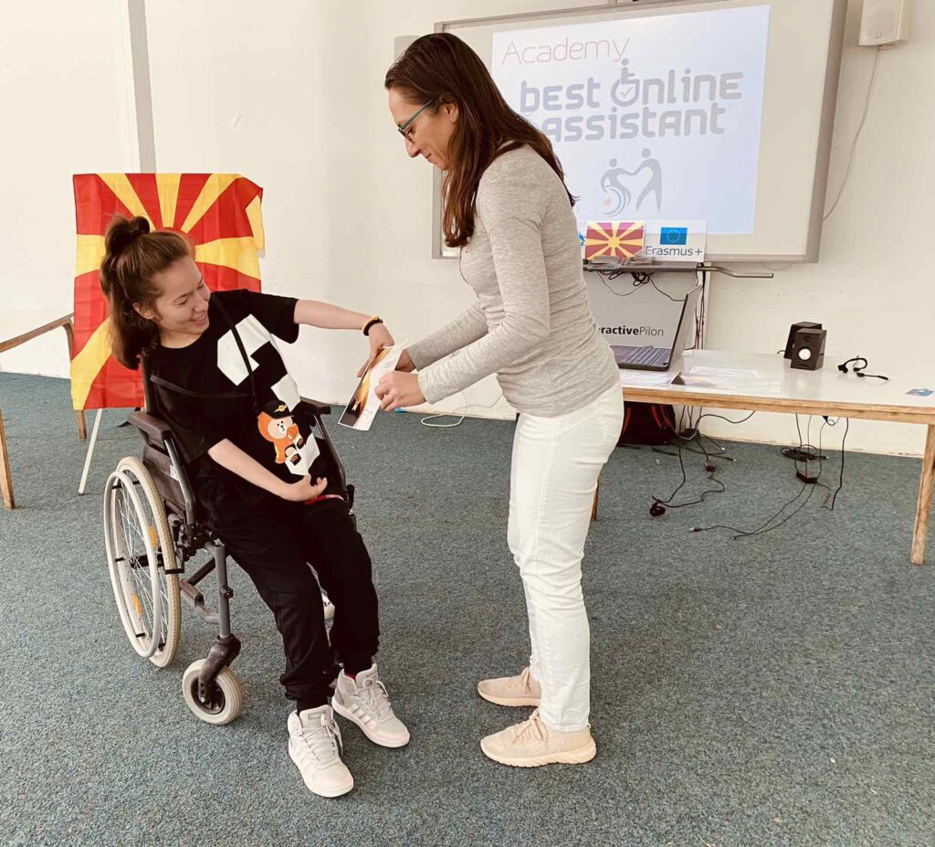 Jana Dimova, a person with cerebral palsy accepting the diploma.