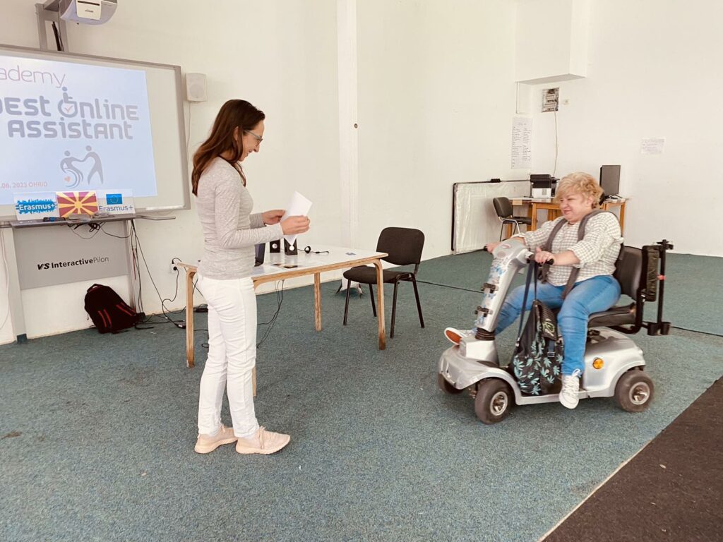 Sonja Gjorgievska, a person with disability driving to the stage to accept the diploma.